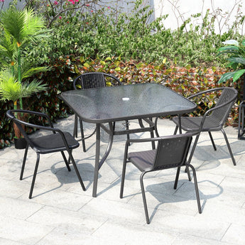 Square outdoor dining table with textured glass top and black metal base
