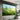 Motorized projector screen with matte black bezel and roller housing