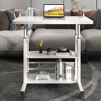 White overbed table with two-tier shelf and caster wheels, holding a laptop and books