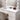 White vanity table with lighted mirror bulbs, tabletop accessories and storage drawers