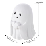 White ghost figurine with cute face and clasped hands, rounded body