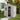 6x4 ft outdoor plastic storage shed with open door, showing shelves inside