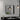 Square bathroom wall mirror with black aluminum frame and rounded corners, light reflections