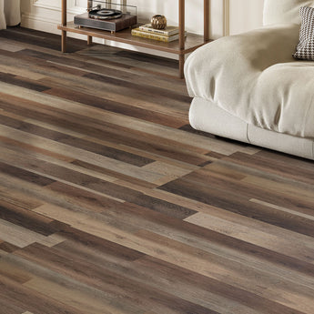 Wood-grain PVC floor planks on self-adhesive tiles, brown and tan staggered layout