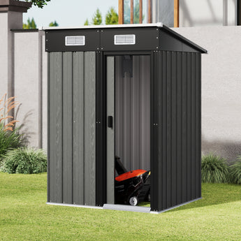 Grey metal garden storage shed with sliding door, pent roof, and vented gables