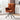 Rust-orange high-back accent chair with padded arms and black tripod swivel base