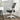 White office chair with mesh back and folding armrests, black seat
