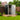 Anthracite metal garden storage shed with double doors open on a small deck