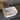 White square countertop sink with silver drain and curved faucet spout