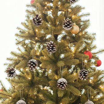 Christmas tree hanging ornaments: pine cones with white accents, plus a few red balls