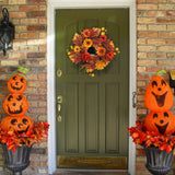 Halloween autumn wreath with orange and yellow blooms and warm glowing lights