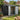 Outdoor metal tool storage shed with open double doors and visible tool organizer shelves