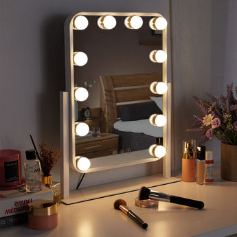 Vanity mirror with 12 illuminated bulbs around the glass, white frame