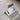 External corner trowel with blue/yellow grip and stainless steel finishing blade