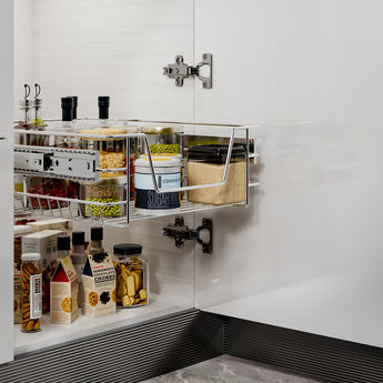 Open cabinet drawer with pull-out wire baskets for jars and pantry items