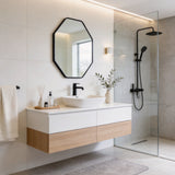 Black octagon wall mirror with towel shelf above bathroom sink