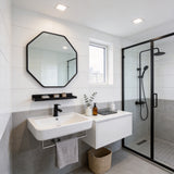 Black octagonal bathroom mirror with aluminium frame and built-in towel shelf
