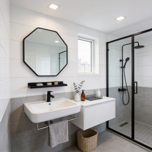 Black octagonal bathroom mirror with aluminium frame and built-in towel shelf