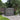 Gray outdoor storage shed with hinged double doors and vented roof grilles