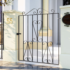 Black metal porch gate with ornamental scroll center and latch bar