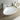 White ceramic oval countertop washbasin with chrome faucet and pop-up drain