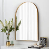 Arch-shaped wall mirror with gold metal frame and clear reflective surface