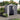 Plastic storage shed with one door open and small window panel detail.