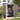Lockable plastic garden storage shed with double doors open, shelves inside.