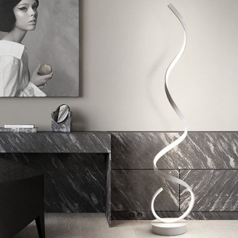 Minimalist LED spiral floor lamp with glowing white curved tube and round white base.