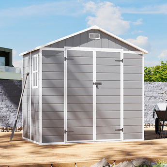 Gray plastic storage shed with double doors closed, apex roof vent and side trim