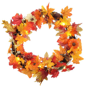 Autumn leaf wreath with red, orange, and yellow leaves, acorns, berries, and lights