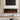 Electric fireplace with black frame and glowing red flame effect over faux logs