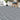 Grey rustic woodgrain PVC flooring planks with chair on top