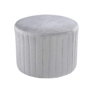 Light gray round velvet ottoman pouf with vertical channel seams and smooth round top