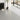 Peel-and-stick PVC floor tile with light gray marble-effect pattern