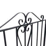 Black metal gate top scroll ornament with curved flourishes