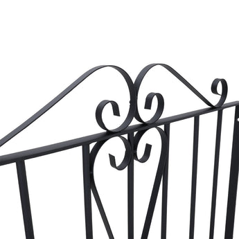Black metal gate top scroll ornament with curved flourishes