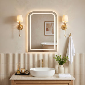 Wall-mounted LED vanity mirror with warm backlit border in a rounded rectangular frame