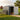 Metal tool shed with open double door, dark gray walls and white door frame
