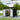 Metal storage shed with flat roof; double doors open, black panels and shelving inside