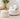 White corduroy swivel accent chair with throw pillows and matching ottoman footstool