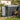 Pent roof metal storage shed with open door, tools storage area and potted plants