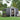 Anthracite metal garden storage shed with open sliding door and apex roof