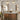Arch-shaped gold-framed wall mirror above a vanity with built-in lights