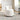 White sherpa swivel storage chair with rounded seat and black base