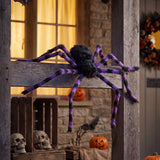 Giant Halloween spider decoration with black body and purple-striped legs on porch beam
