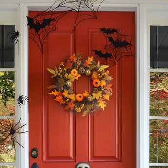 Halloween door wreath with orange, black, and gold leaves, pinecones, and pumpkins