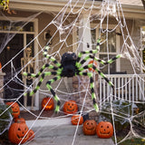Giant Halloween spider decoration with green-striped legs and white web across doorway