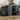 Metal garden storage shed with double doors open, grey corrugated walls, and two roof vents