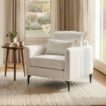 Linen sofa armchair with off-white cushions, two pillows, and tapered black legs